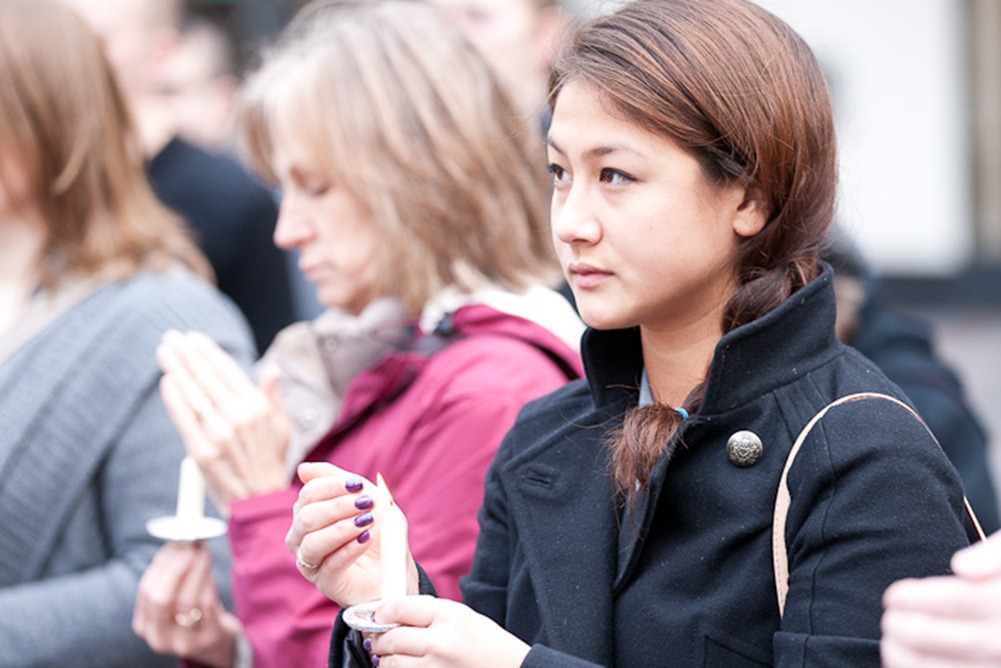 Protecting her candle, Odessa Stevens, a Washington Cease Fire board member, participates in a vigil remembering victims of gun violence at Westlake Park in Seattle, WA on Sunday, Jan. 8, 2012. Washington Cease Fire was founded in 1983 and works to reduce gun violence in communities across Washington State. (Photo/Neil Enns)