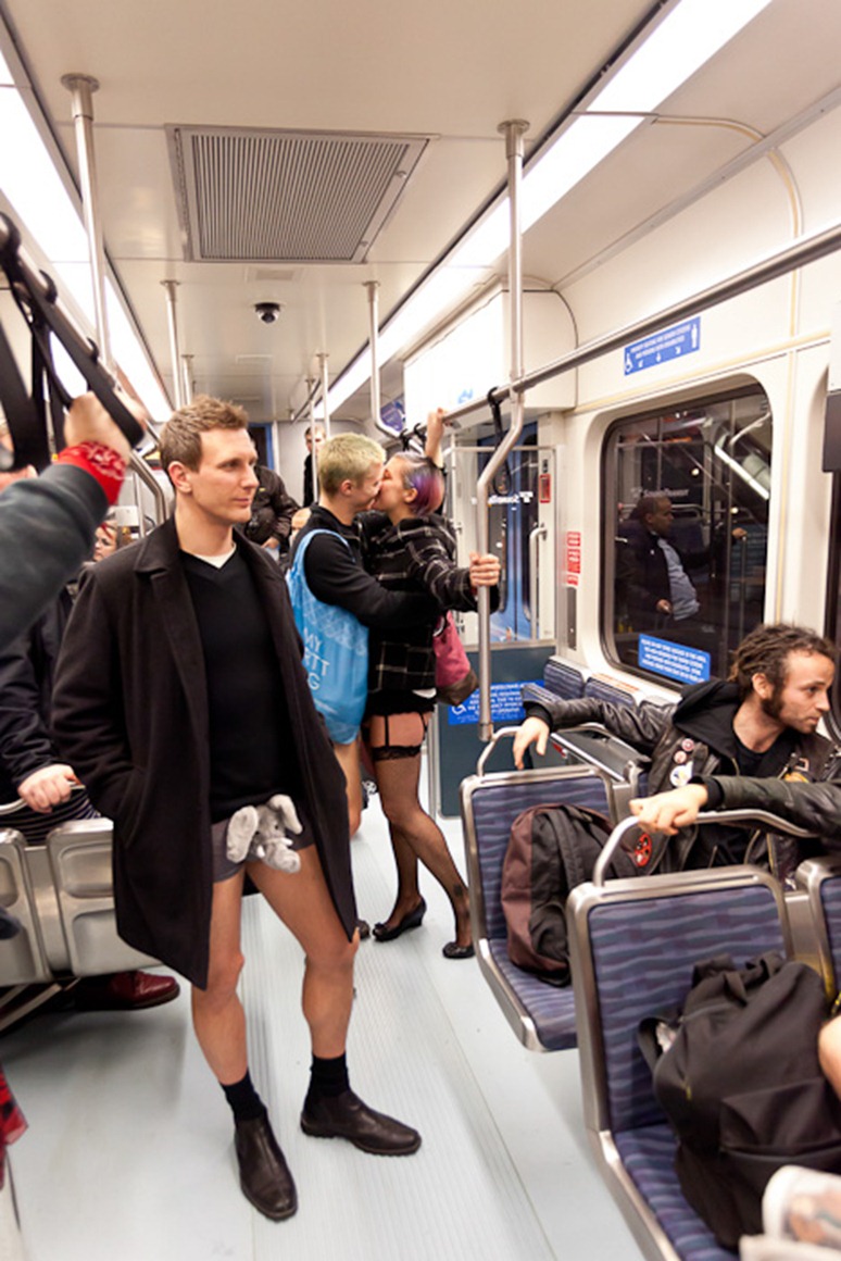 Kissing couple Derek Covey and Amber Haworth ride a SoundTransit train during No Pants Light Rail day in Seattle on Sunday, Jan. 8, 2012. In its third year in Seattle, No Pants Subway rides were started 10 years ago in New York City by Improv Everywhere. (Photo/Neil Enns)