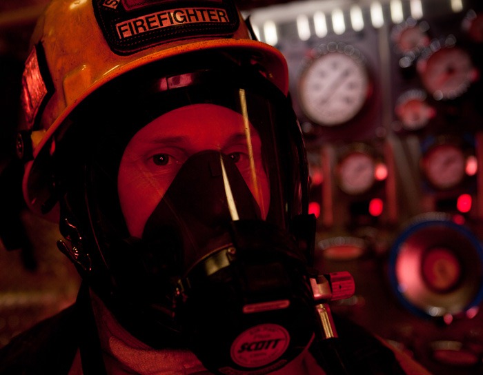 Standing in front of a fire engine in Snohomish, WA, on Wednesday, Jan. 25, 2012, firefighter/EMT Matt Nutterbrock is dressed in full protective gear. Nutterbrock is a three year veteran of the department, based at Station 72, headquarters for Snohomish County Fire District 7. (Photo/Neil Enns)