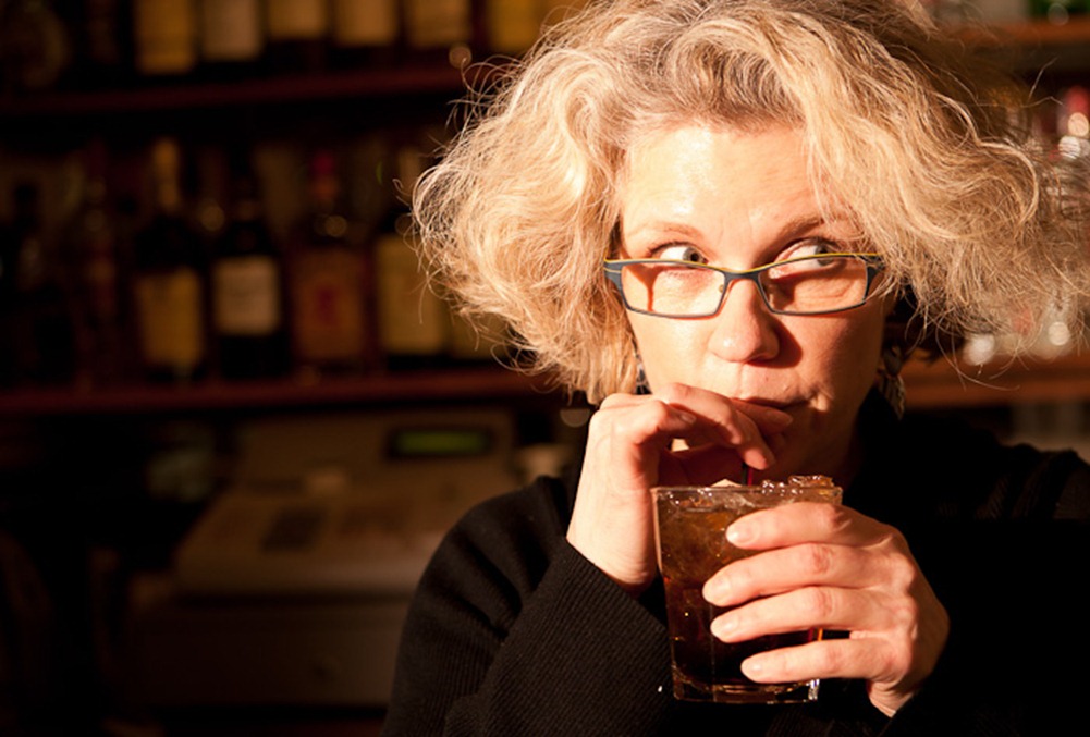 Sipping a non-alcoholic beverage, Colleen Richardson takes a break while bartending at the Granite Curling Club in Seattle, WA, on Monday, Jan. 23, 2012. A volunteer, Richardson has been the Monday League bartender for the past three years. (Photo/Neil Enns).