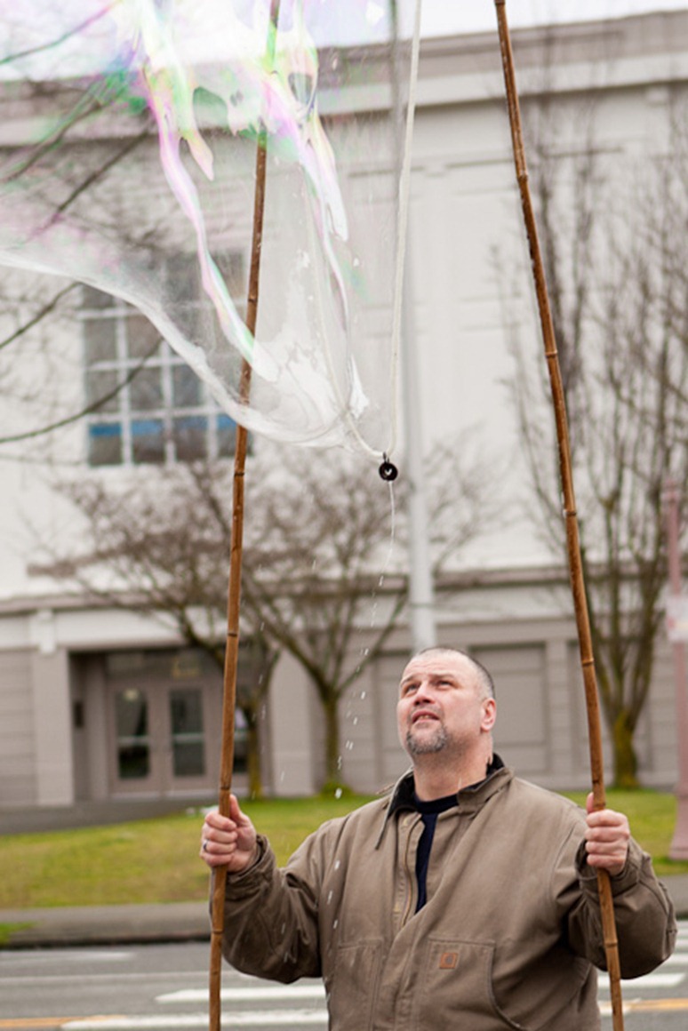 Watching his bubble, Eddie Blunt brightens a dreary day in Everett, WA, on Sunday, Jan. 22, 2012. Blunt's favourite location to practice his craft is outside Providence Children's Center in downtown Everett, which he says gives him "the most bang" for each bubble. (Photo/Neil Enns)