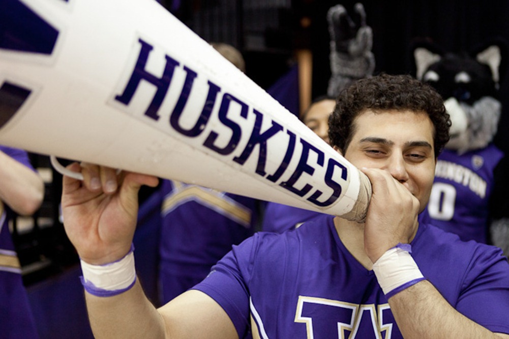 Holding his megaphone, Senior Shadain Akhauan cheers the University of Washington Husky Women during a basketball game in Seattle, WA, on Thursday, Jan. 26, 2012. The Huskies beat the Arizona Wildcats 77-48 and improved their record to 3-5. (Photo/Neil Enns).
