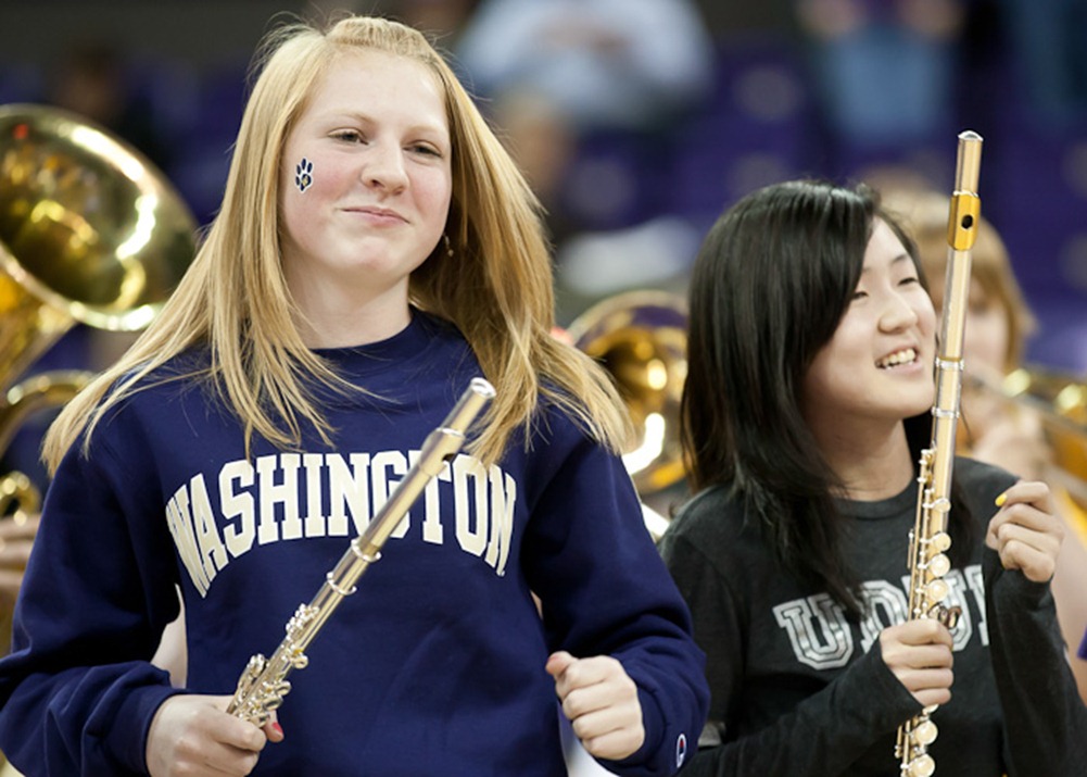 Dancing during a song, 14-year-old Caryln Beaudry, left, and 13-year-old Jubilee Cho, right, perform with the Whitman Middle School Grade 8 band during halftime at the University of Washington Husky Women's basketball game in Seattle, WA, on Thursday, Jan. 26, 2012. The Husky Women beat the Arizona Wildcats 77-48. (Photo/Neil Enns)
