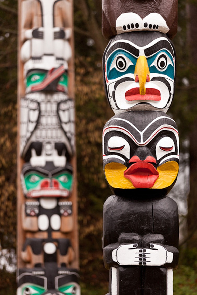 The Kakaso'las totem pole, front, stands in Stanley Park, Vancouver, BC, on Sunday, Feb. 12, 2012. Carved by Ellen Neel and her uncle Mungo Martin, the pole was completed in 1955 for the Woodward's Department Store. (Photo/Neil Enns)
