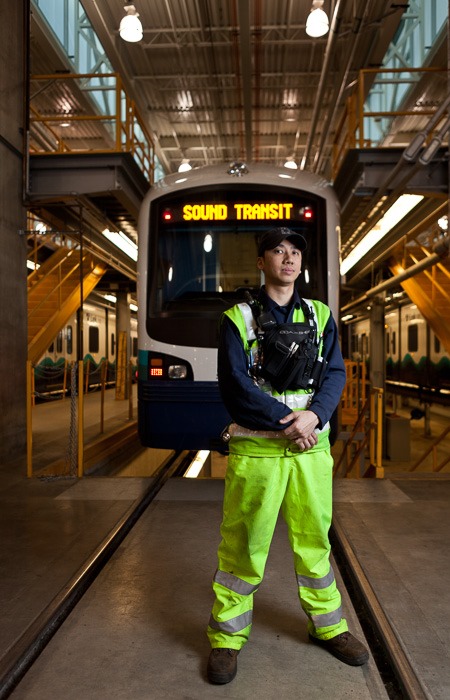 Electromechanic Calvin Lee stands in front of one of the trains maintains at the service facility in Seattle, WA on Tuesday, March 6, 2012. Lee has worked at SoundTransit since it started operating 3 years ago. (Photo/Neil Enns)