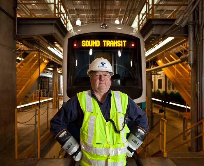 Electromechanic Stephen Lee stands in front of one of the trains maintains at the service facility in Seattle, WA on Tuesday, March 6, 2012. Lee, a proud Cherkoee, has worked at SoundTransit since it started operating 3 years ago. (Photo/Neil Enns)